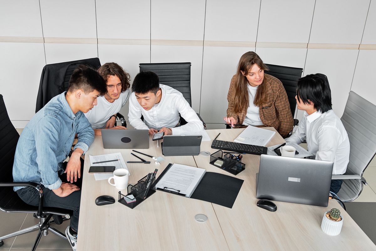 A team looking at laptops around a table